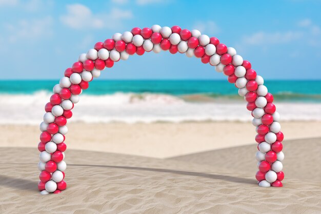 Concept de vacances d'été. Ballons blancs et rouges en forme d'arc, de porte ou de portail sur un gros plan extrême de la côte déserte de l'océan. Rendu 3D