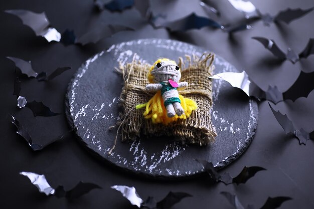 Concept de vacances d'Halloween Vieille table en pierre en forme de chauves-souris Décorations en papier d'Halloween sur fond sombre Jouet de lune