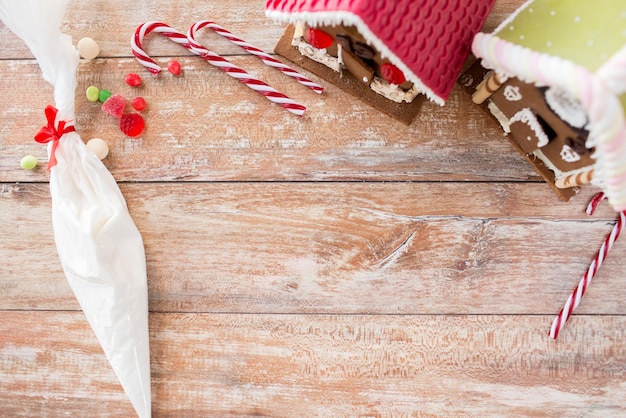 concept de vacances, de noël, de pâtisserie et de bonbons - gros plan de belles maisons en pain d'épice à la maison