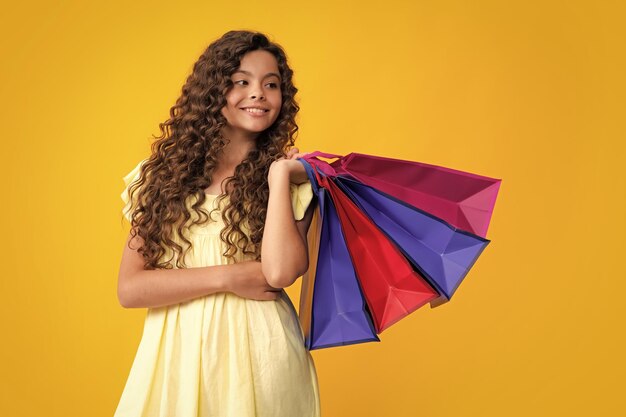 Concept de vente et de shopping Teen girl holding shopping bags isolé sur fond de studio