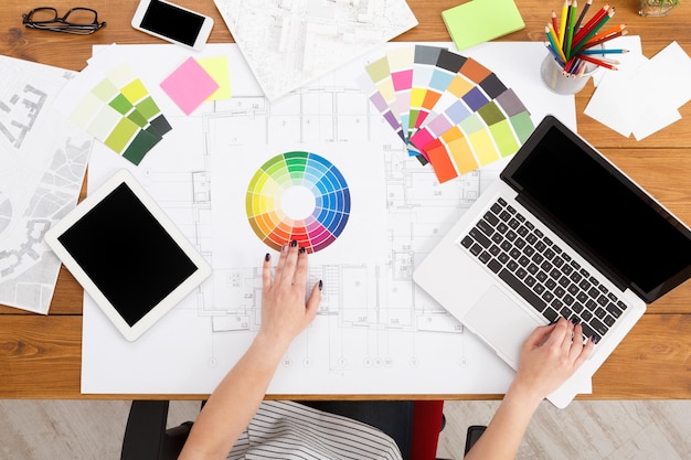 Concepteur travaillant avec une palette de couleurs dans un intérieur de lieu de travail moderne, vue de dessus, espace de copie. Projet de conception de maison au bureau.