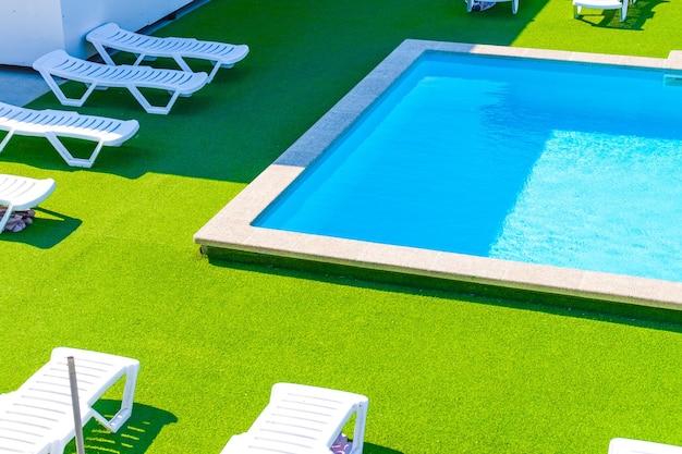 Conception de la piscine dans une résidence moderne Chaises longues pour le temps ensoleillé Vacances