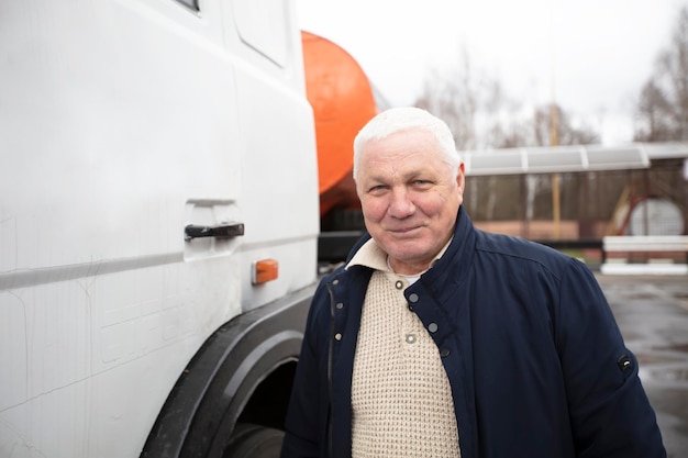 Un conducteur âgé à la cabine d'un gros camion