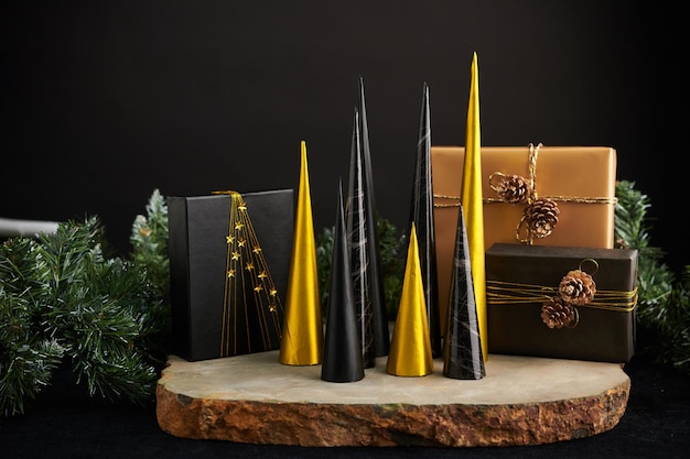 Cônes en papier doré et noir comme arbres de Noël et cadeaux pour la décoration de la maison