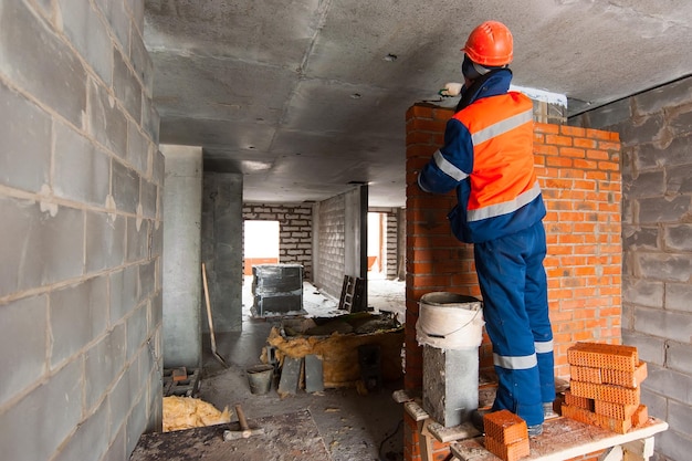 constructeur maçon présente la maçonnerie d'une nouvelle maison