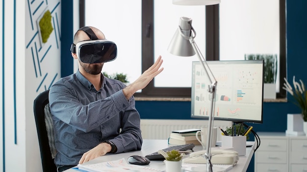 Consultant commercial travaillant avec des lunettes vr pour la croissance de l'entreprise, utilisant un casque de réalité virtuelle avec simulation interactive 3d. Assistant de recherche analysant la présentation du diagramme de vente.