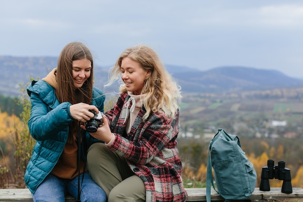 Les copines se reposent sur un banc dans les montagnes