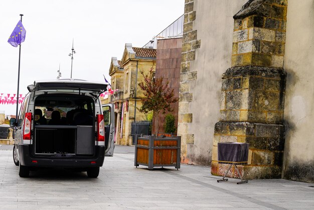 Corbillard ouvert et vide garé à côté de l'église