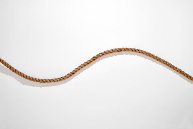 Photo corde ondulée en fibre naturelle avec ombre sur fond blanc
