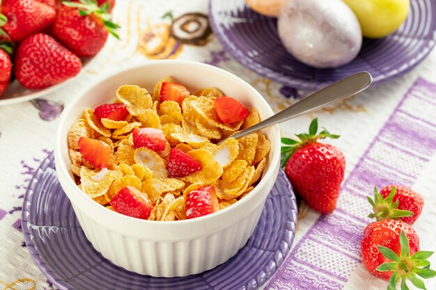 Cornflakes petit déjeuner sain et fraises avec du lait et des œufs durs sur Easte. Bio sain. Fermer