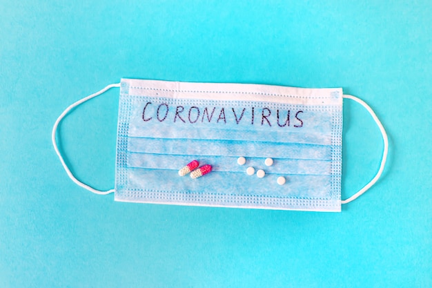 Coronavirus. Remèdes. Masques sur une surface bleue. Mise au point sélective.