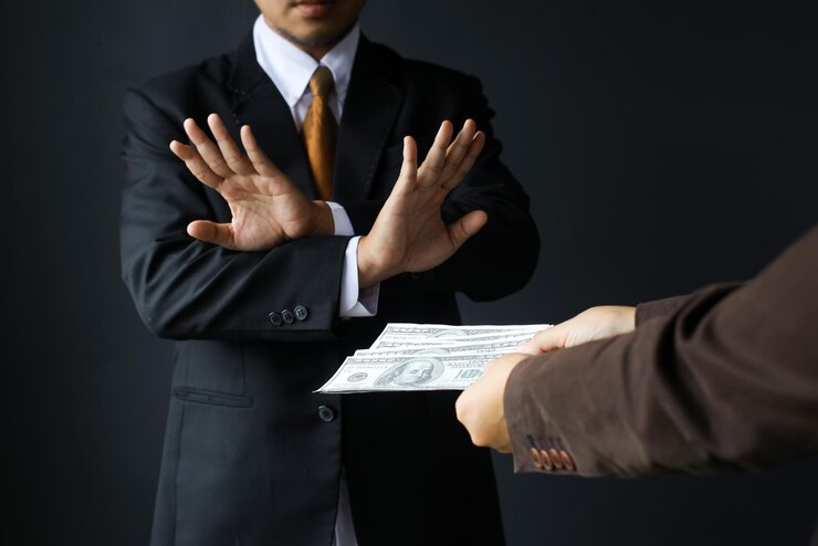 Corruption et pots-de-vinLe directeur d'un homme d'affaires refuse de recevoir des billets d'un dollar pour conclure un contrat