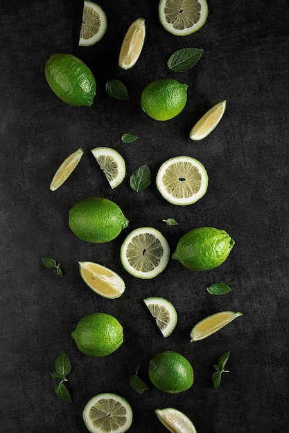 Photo corte de limones verdes con hojas de menta.