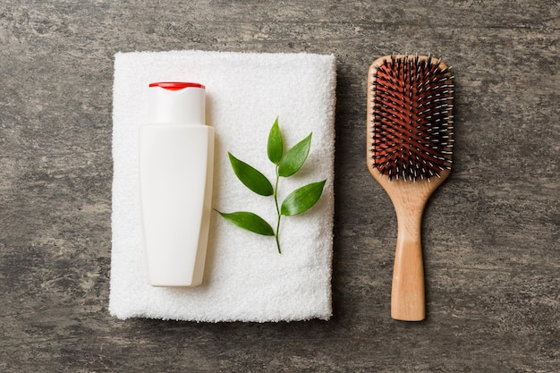 Cosmétique pour crème de soin des cheveux et serviette sur fond coloré vue de dessus à plat