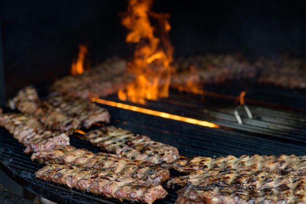 Côtes levées américaines de barbecue faisant cuire sur le gril