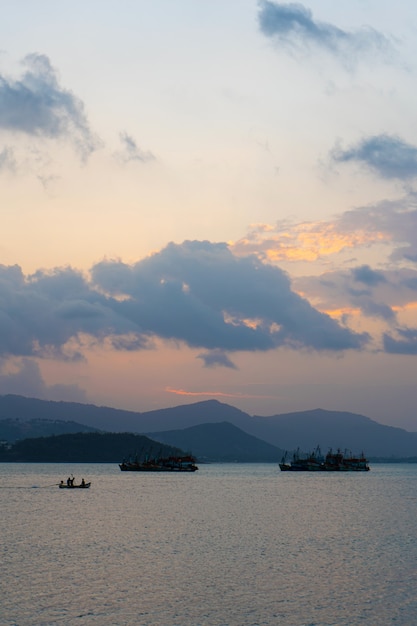 Coucher de soleil sur la baie avec des bateaux de pêche.