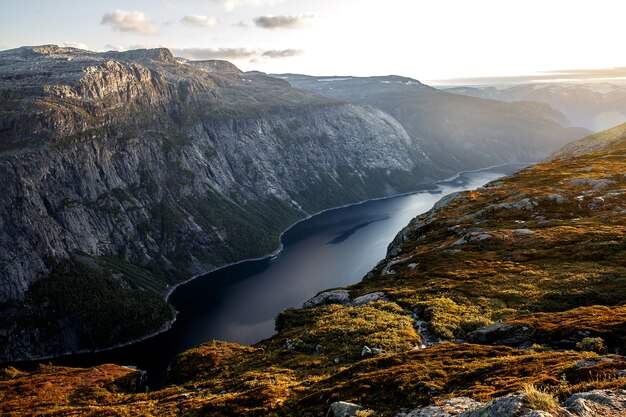 Photo coucher de soleil dans les montagnes norvégiennes. la lumière orange sur le fjord.