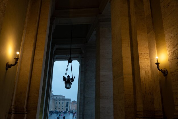 Un couloir sombre avec deux bougies allumées suspendues au plafond