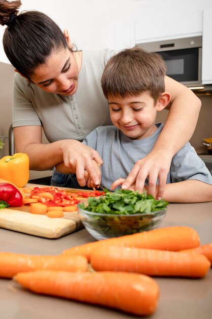 Coup moyen mère et enfant couper les légumes