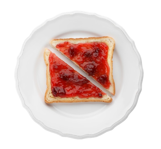 Couper du pain grillé avec de la confiture sur une assiette isolée sur blanc