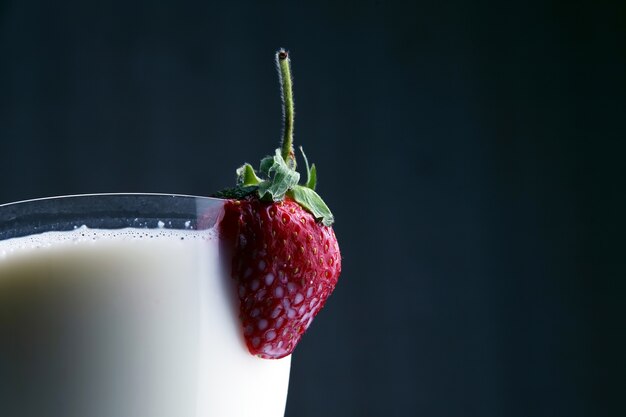 Couper les fraises dans un verre avec du lait