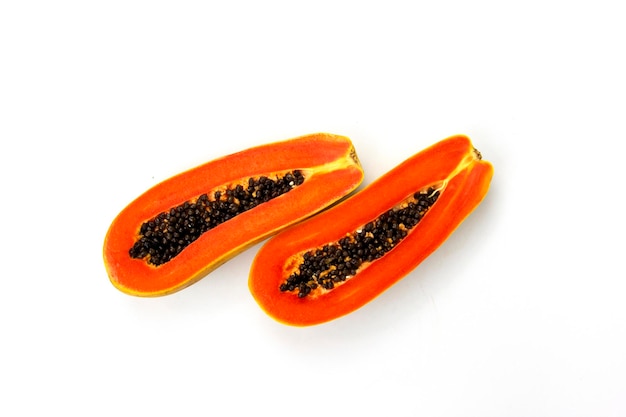 Coupes de papaye isolées sur fond blanc avec deux morceaux de délicieuse papaye au milieu de blanc