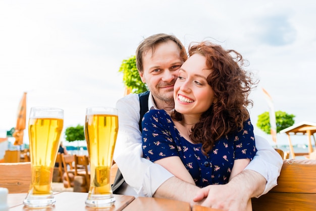 Couple amoureux câlinant dans le café en plein air