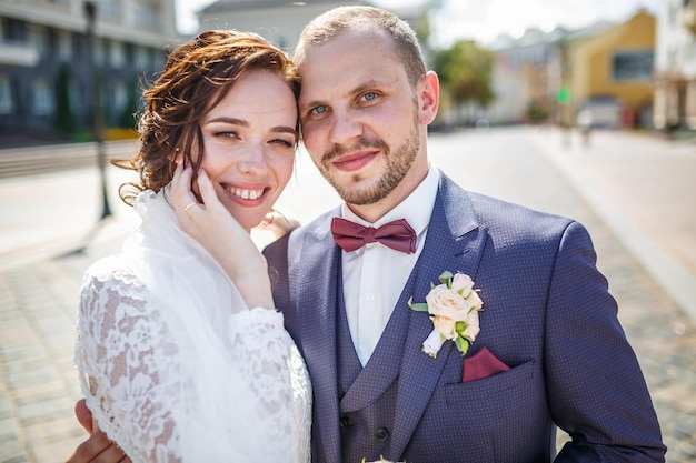 Un couple d'amoureux de jeunes mariés se promène dans la vieille ville en journée ensoleillée d'été