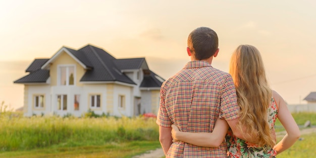 Couple d'amoureux regardant leur maison