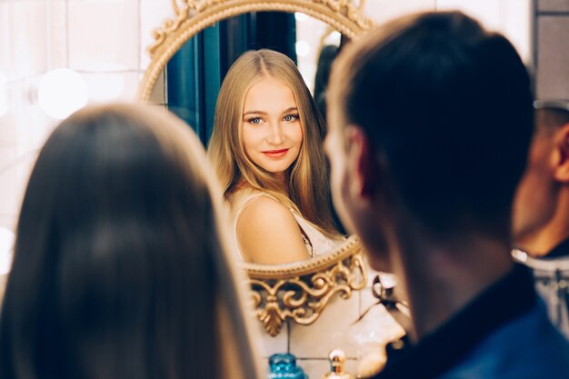 Couple d'amoureux s'embrassant dans le miroir de la salle de bain. Couples de style de vie qui s'aiment