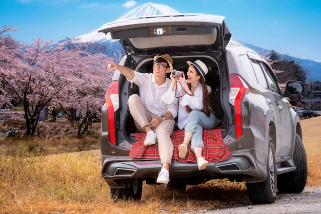 Couple asiatique voyage dans la montagne Fuji en voiture suv