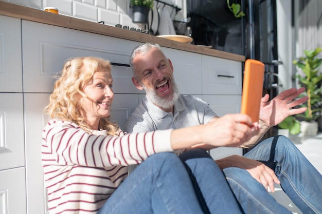 Un couple ayant un appel vidéo et ayant l'air apprécié