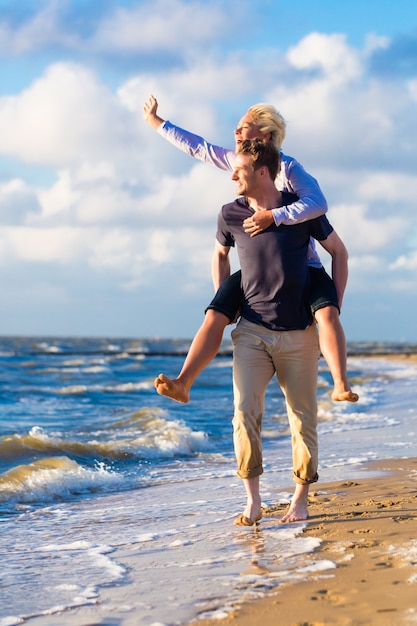 Couple bénéficiant d'un coucher de soleil romantique à la plage de la mer du Nord allemande