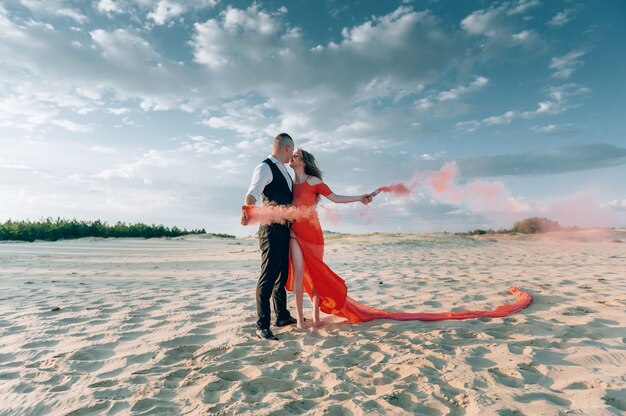 Couple charmant élégant posant sur la plage