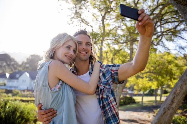 Couple en cliquant sur un selfie dans le parc