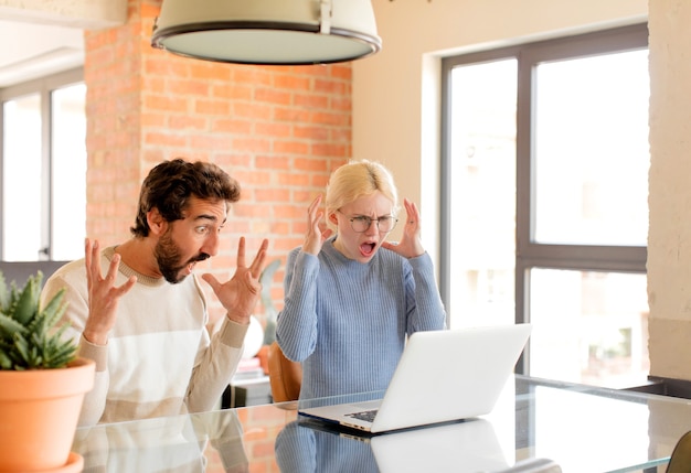 couple criant avec les mains en l'air, femme furieuse, frustrée, stressée et contrariée