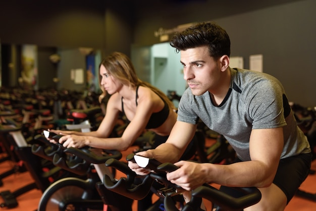 Couple dans une classe de spinning portant des vêtements de sport.