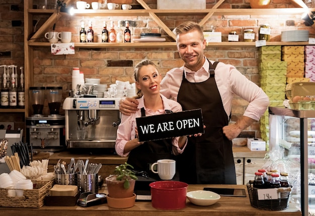 Couple dans leur nouveau café fiers propriétaires d'entreprises de nouvelles