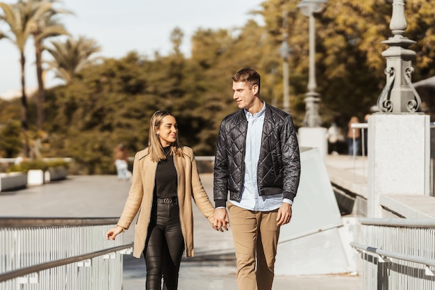 Couple fiancé marchant sur une rampe main dans la main