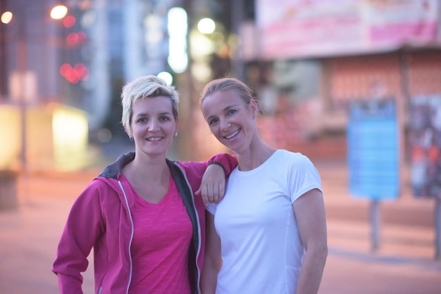 couple de jogging s'échauffant et s'étirant avant de courir le matin dans la ville