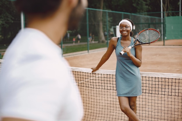 Couple jouant au tennis sur un court de tennis