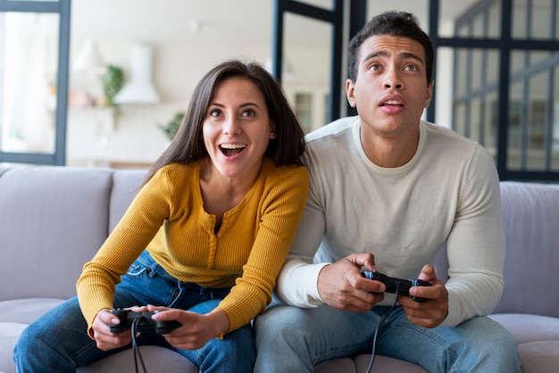 Photo couple jouant à des jeux vidéo ensemble