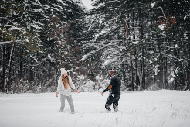 Couple, jouer, neige, forêt