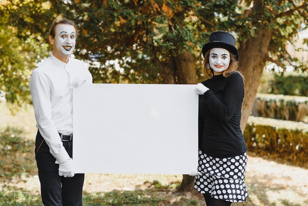 Couple mimes drôles tenant signe