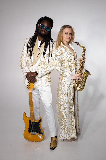 Un couple de musiciens, un homme africain et une femme caucasienne, jouent d'instruments.