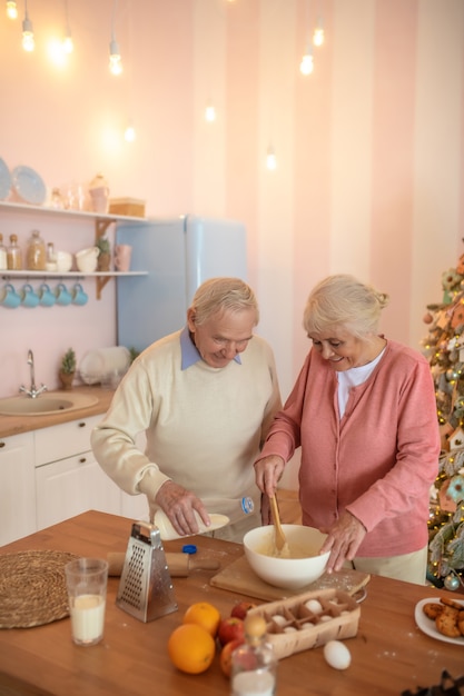 Couple de personnes âgées cuisine dans la cuisine