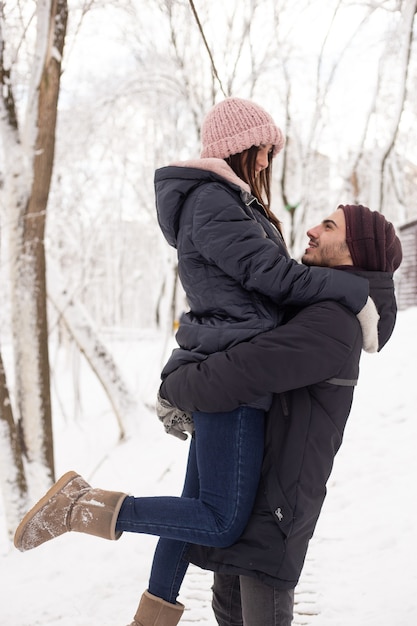 Couple profitant de l'hiver et de la neige dans le parc