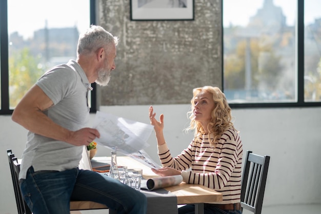 Un couple regardant à travers des papiers et discutant de quelque chose