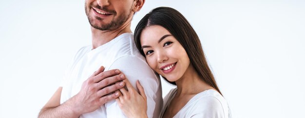 Le couple romantique debout sur le fond blanc