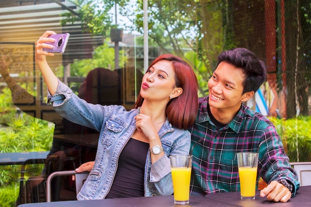 Couple romantique prenant une photo de selfie au café